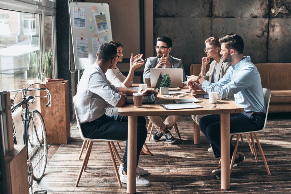 Young people sitting around a table in a coworking space