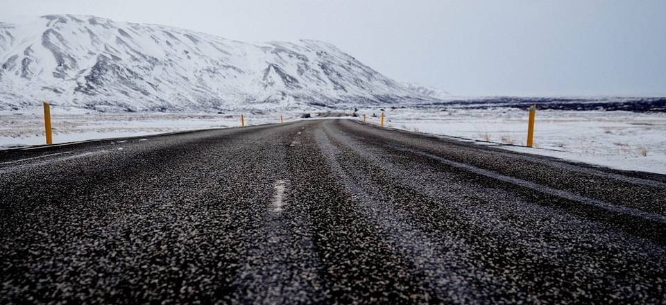 High-performance emulsion for cold microsurfacing and bitumen slurry. Road and snow-capped mountains