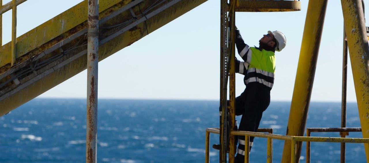 Mobility. An operator looks out to sea from behind the rig railings
