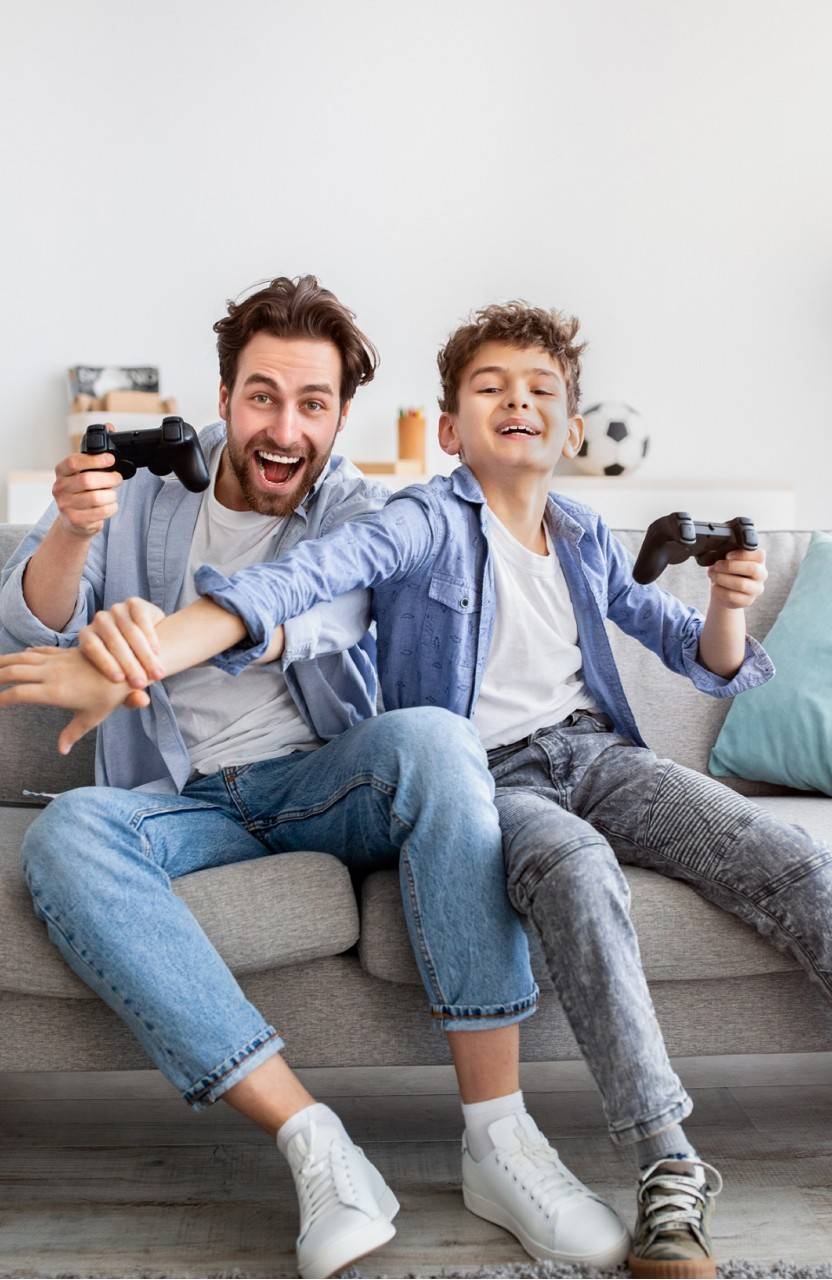 An adult and a child playing video games